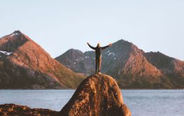 Travel in Norway outdoor man raised arms active healthy life