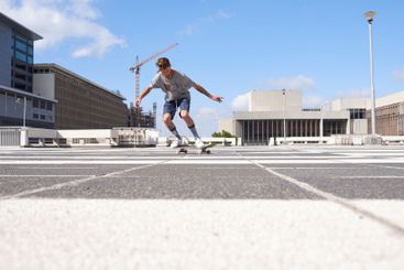 Man, ride and city with skateboard on asphalt for trick,...