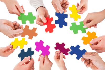 Business People Holding Colorful Jigsaw Pieces