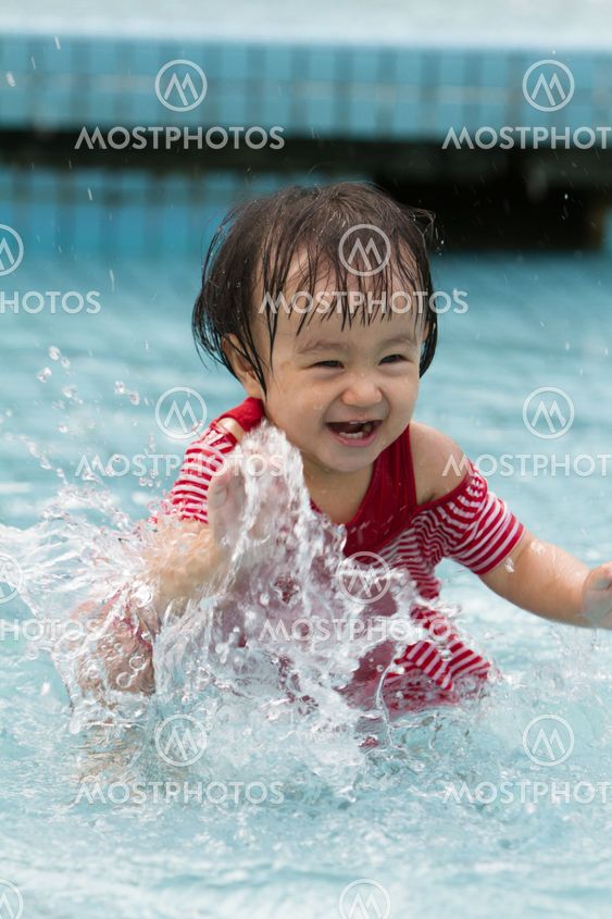 Chinese Little Girl Playing in Water