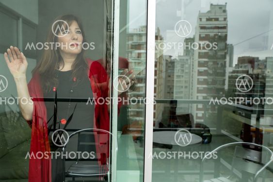 Mature woman looking out the window