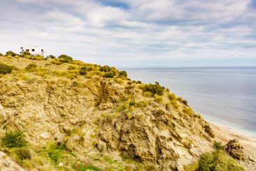 Camper on cliff, coast in Spain