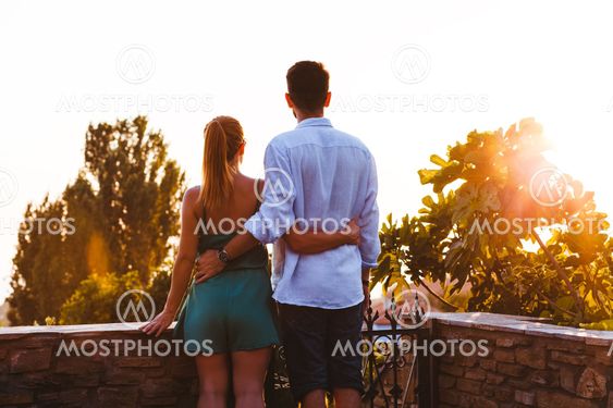 Young couple enjoying sunset on their travel