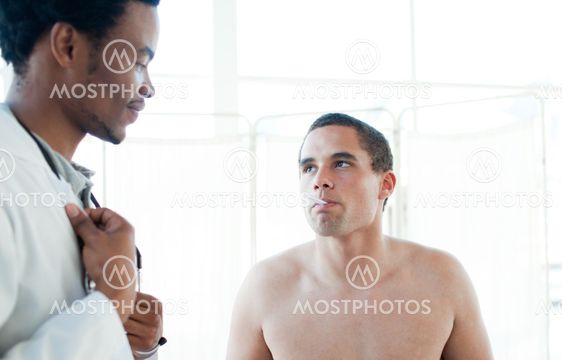 A doctor taking her patient temperature with a thermometer