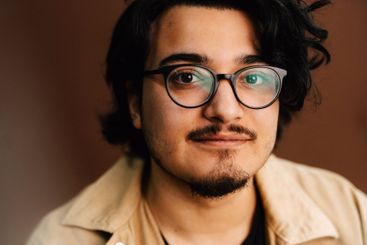 Portrait of man wearing eyeglasses in studio