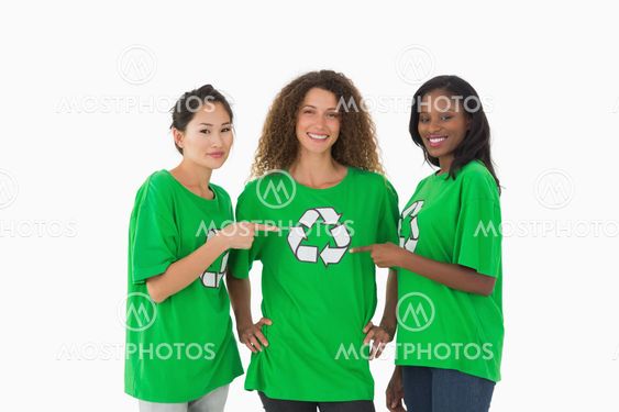 Team of environmental activists smiling at camera pointing to tshirt