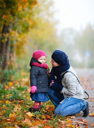 Mother And Daughter Outdoors On Foggy Day