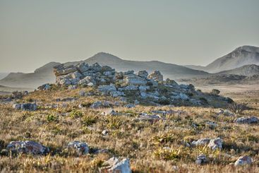 Wilderness, grass and rocks with hills landscape for...