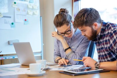 Businesswoman and businessman working in office