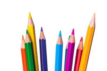 Vibrant colored pencils arranged in a pattern on white...