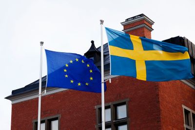 the Swedish and European flag waving in the wind