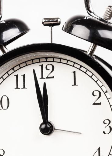 Close up of a black vintage alarm clock