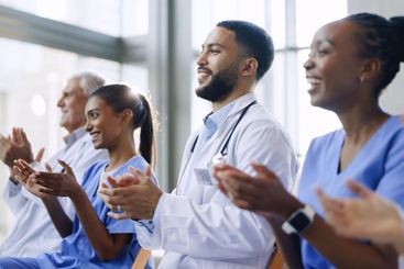 Doctors, happy and applause for celebration with...