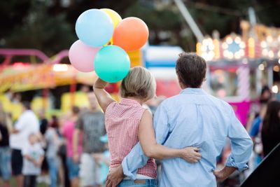 Senior couple having a good time at the fun fair