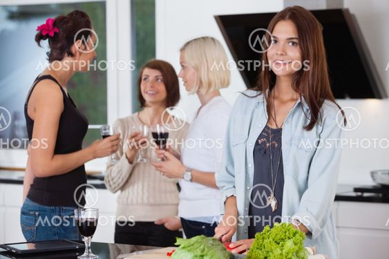 Female cutting vegetables on kitchen counter