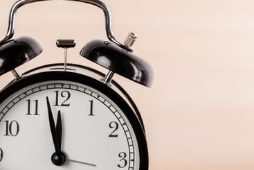 Close up of a black old-fashioned alarm clock