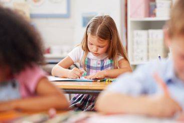 Little girl, preschool and coloring with book in class...