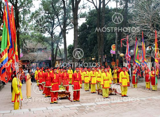Group of people in traditional costume give gifts to the...