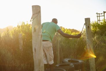 Fitness, man and walking on obstacle outdoor for...