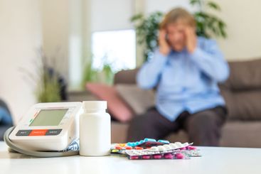 An old woman measures her blood pressure. Selective focus.