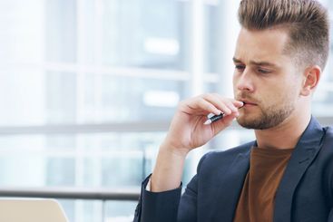 Thinking, laptop and business man with pen in office for...