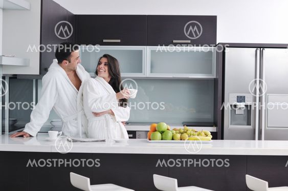 young couple have fun in modern kitchen