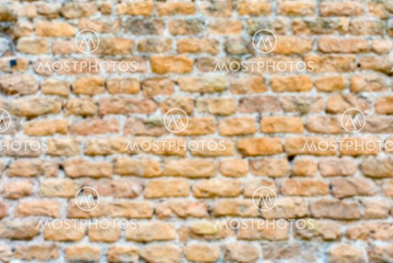 Defocused background of stone brick wall texture with copy space