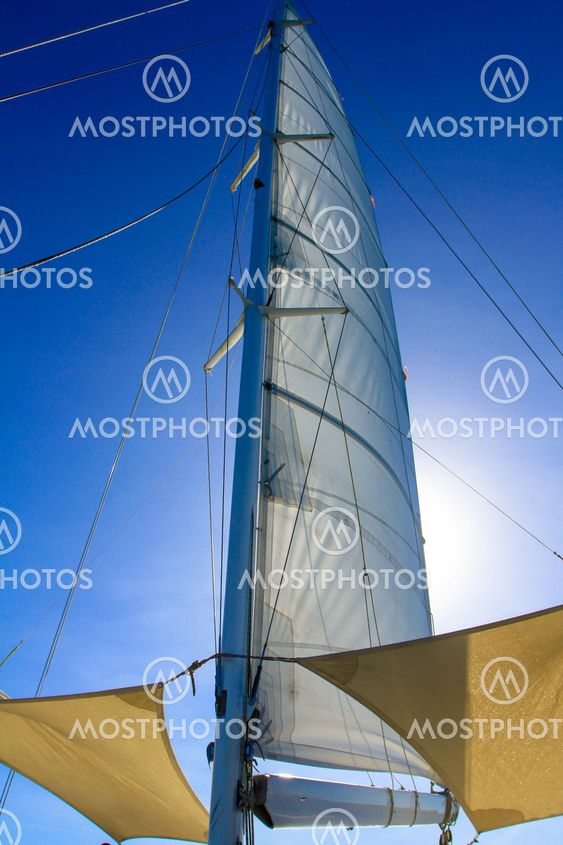 Looking at boat mast with rigging and blue sky