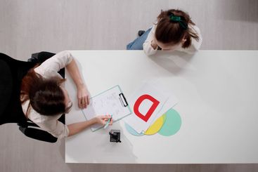 Caring psychiatrist comforts sad child during therapy...