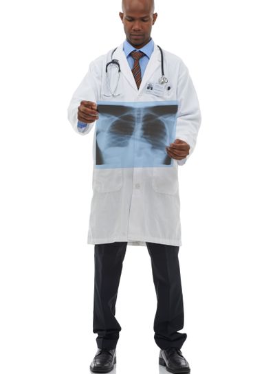 Surgeon, black man and check xray scan for lung cancer...