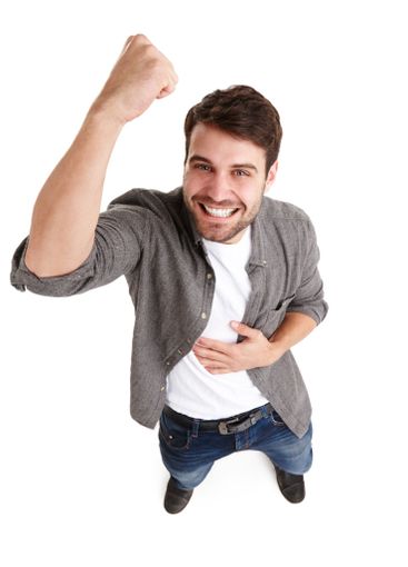 Man, fist pump and celebrate winning in studio,...