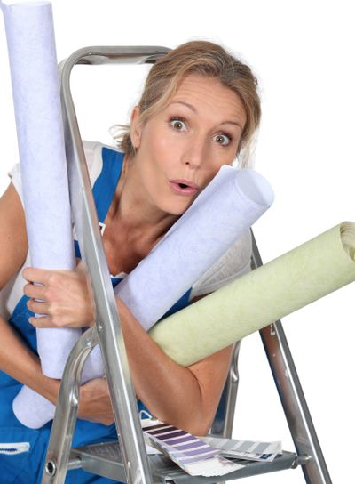 Woman with rolls of wallpaper