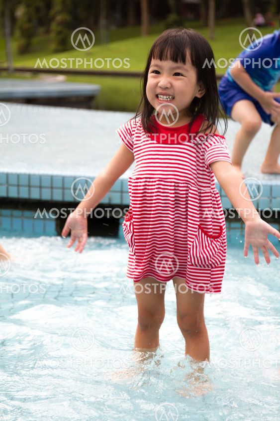 Chinese Little Girl Playing in Water