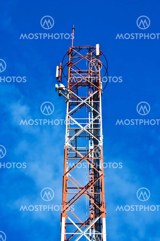 communication antennas, radio telephone mobile phone antennas on blue sky background