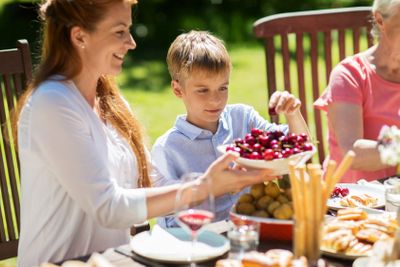 happy family having dinner or summer garden party