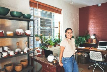 Pottery, workshop and woman with smile in portrait for...