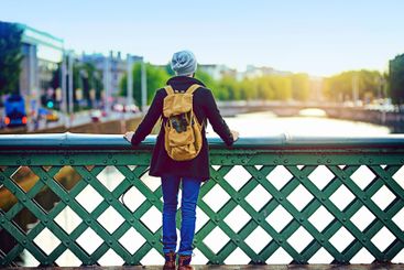 Man, bridge and sightseeing in city for tourism, scenery...