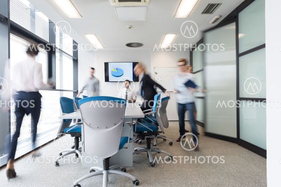 business people group entering meeting room, motion blur