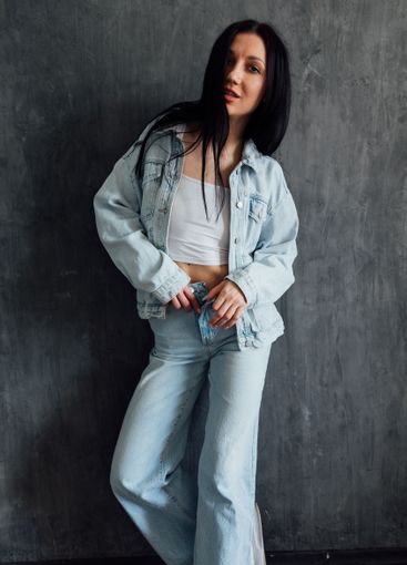 Beautiful slim fashion brunette woman in denim suit