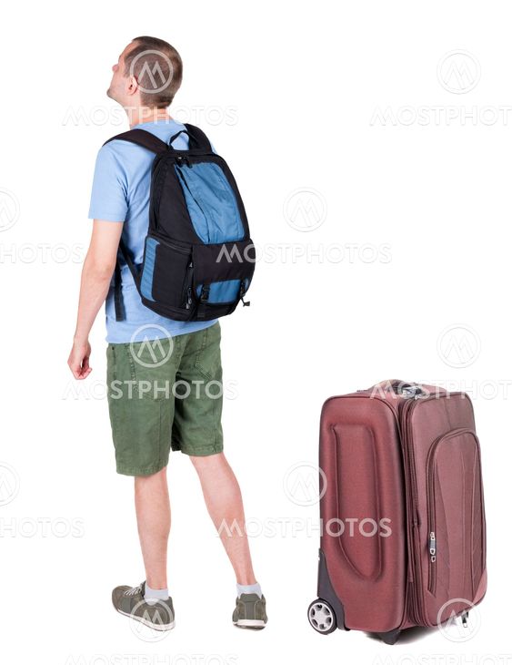 Back view of young man traveling with suitcas.