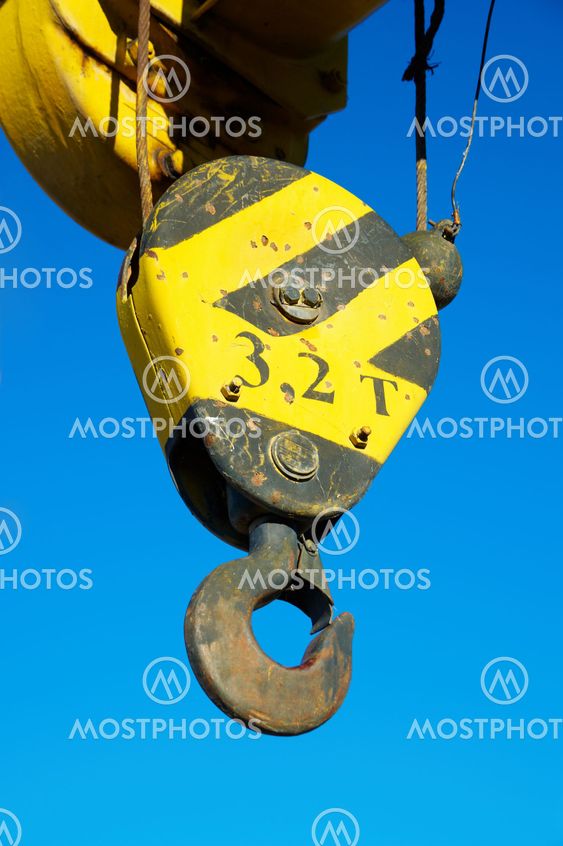 Hook of the old crane in the blue sky