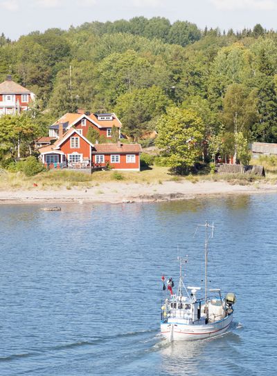 Small fishing boat on the blue sea heading back after...
