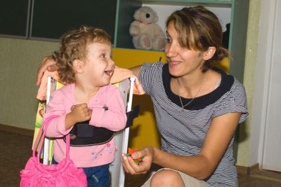 Happy mother and daughter with mobile phone