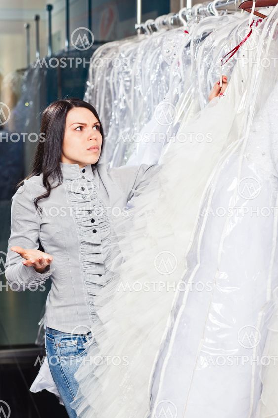 Beautiful girl chooses her wedding dress. Portrait in...