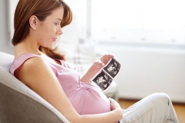 Woman, apartment and smile for pregnancy with scan of...