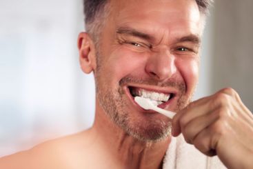 Close-up Of Man Brushing Teeth