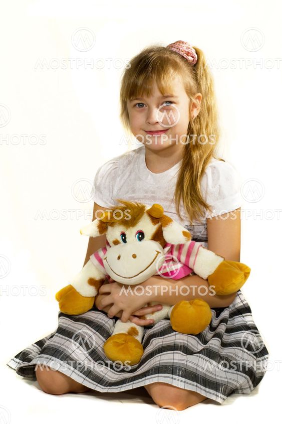 Beautiful little girl playing with a bear.