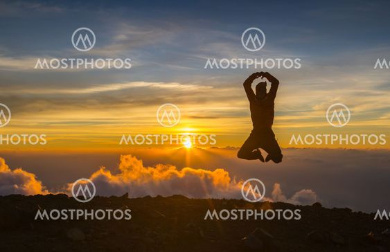 Man jump through the gap on sunset fiery background....