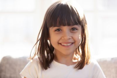 Head shot portrait of laughing adorable little girl