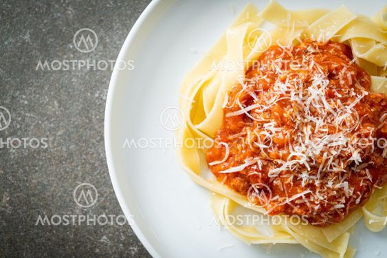 pork bolognese fettuccine pasta with parmesan cheese